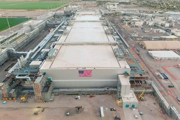 An aerial view of Intel's Fab 62 in Arizona with an American flag hanging from the side.