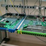 STH AWS Networking Lab Tour – Blue 3.2 Tbps and green 12.8 Tbps switches on the bench